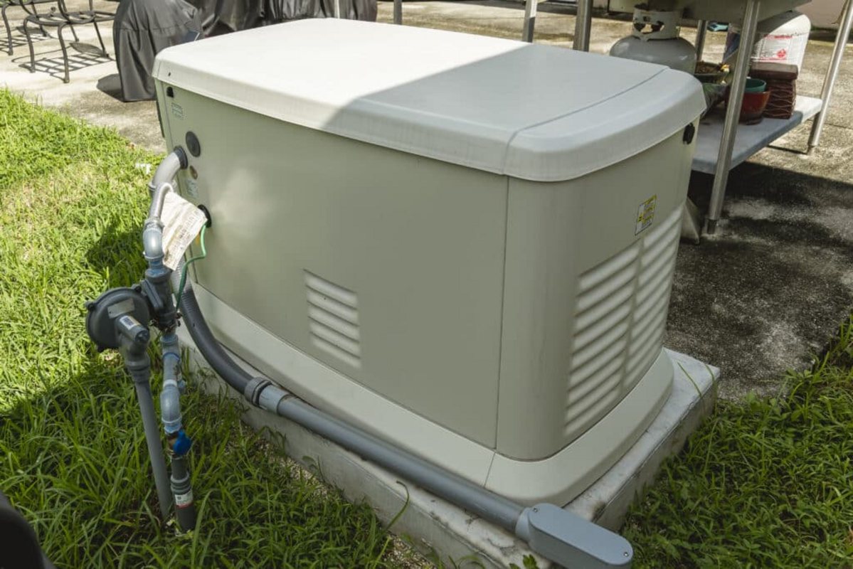 Whole-home standby generator installed beside a house